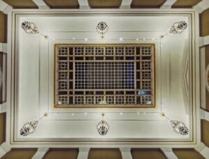 thi công vách ngăn thạch cao chuyên nghiệp đất đỏ | Elegant view from below of an ornate ceiling featuring chandeliers and a