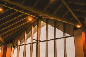 báo giá báo giá trần thạch cao bà rịa | Elegant modern architecture featuring wooden beams and warm lighting inside a buildin