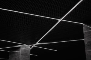 báo giá báo giá trần thạch cao long điền | Black and white abstract view of a modern ceiling with geometric light patterns an