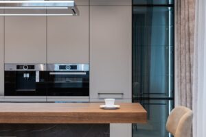 báo giá thi công trần thạch cao giật cấp bà rịa | Modern room with kitchenware and counter with coffee cup near chairs and cu