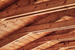 báo giá thi công trần thạch cao khách sạn phú mỹ | Close-up of a rustic wooden ceiling with exposed beams and natural wood te