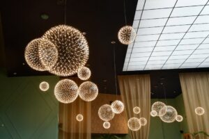 báo giá thi công trần thạch cao nhà hàng vũng tàu | Elegant modern interior with glowing spherical chandeliers and glass ceil
