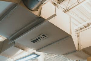báo giá thi công trần thạch cao phòng khách vũng tàu | Close-up view of an air duct labeled 'SUPPLY' in an industrial setting