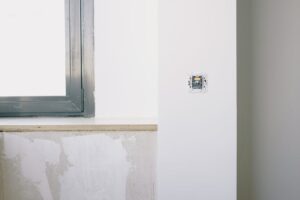 báo giá vách thạch cao giá rẻ vũng tàu | Repairs and installation of new electrical outlet on white wall near window in light