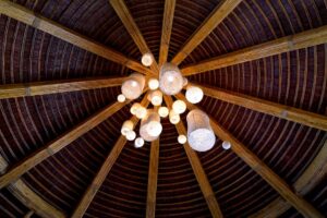 thợ báo giá vách thạch cao long điền | A stunning bamboo ceiling showcasing a central chandelier with glowing lamps, emphasiz
