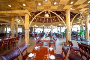 báo giá thi công trần nhựa bà rịa | Interior view of a spacious bamboo-themed restaurant with arranged seating and unique des