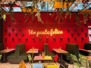 báo giá thi công trần nổi bình châu | Vibrant restaurant setting with modern decor and neon lighting, creating a cheerful din