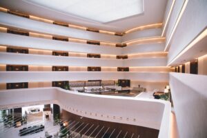 báo giá thi công trần thạch cao biệt thự bà rịa | Spacious modern hotel atrium with sophisticated design and ambient lighting