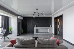 báo giá thi công trần thạch cao khách sạn châu đức | Contemporary living room with a modern black accent wall, chic furniture