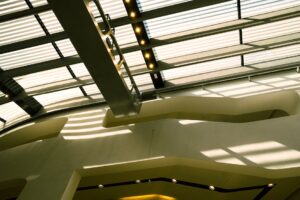báo giá thi công trần thạch cao quán cafe mỹ xuân | A contemporary ceiling design casting geometric shadows, showcasing moder